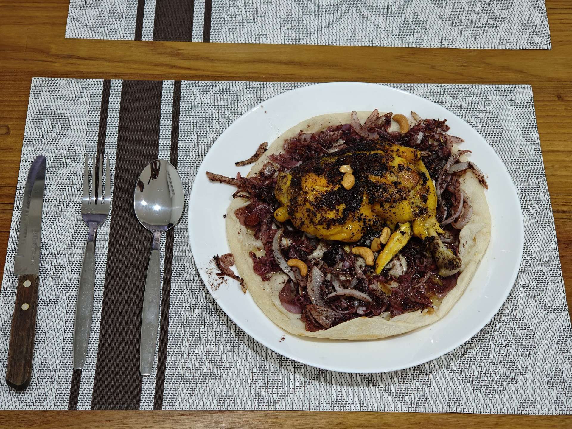 Traditional Palestinian musakhan — sumac chicken over taboon bread with caramelised onions